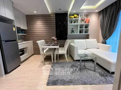 Modern open-layout living room with sleek kitchen and stylish decor