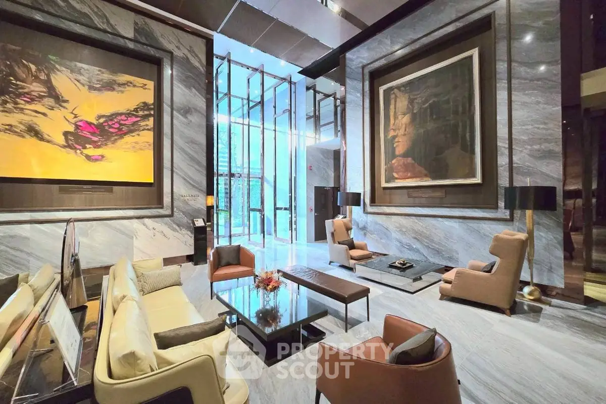 Luxurious modern lobby with elegant seating and large artwork, perfect for upscale living.