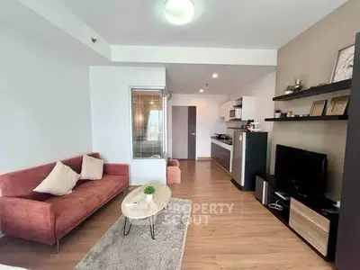 Modern living room with stylish furniture and open kitchen layout in a cozy apartment.