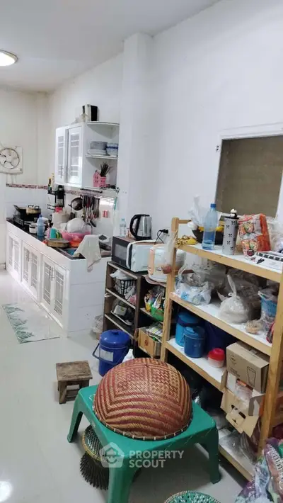 Cozy kitchen with open shelving and modern appliances in a compact space