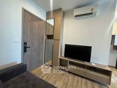 Modern living room with sleek wooden furniture and air conditioning, perfect for cozy urban living.