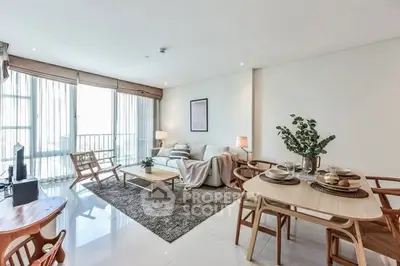 Spacious modern living room with elegant dining area and large windows.