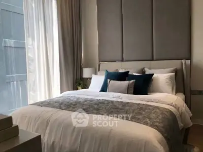 Luxurious bedroom with elegant decor and ample natural light