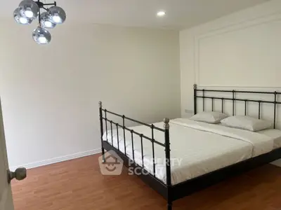 Spacious bedroom with modern metal bed frame and elegant lighting