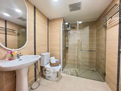 Modern bathroom with glass shower and elegant fixtures in a stylish real estate property.