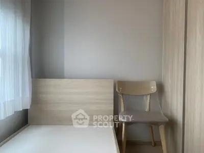 Minimalist bedroom with wooden furniture and natural light