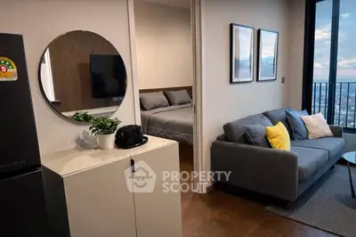 Modern apartment interior with cozy living room and stylish bedroom, featuring a sleek sofa and decorative elements.