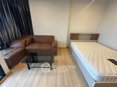 Modern studio apartment with cozy sofa and comfortable bed, perfect for urban living.
