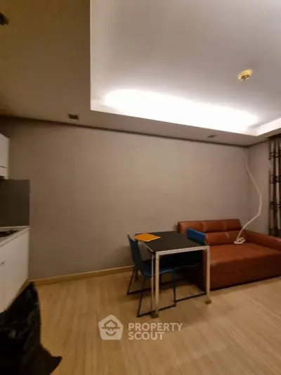 Modern living room with sleek furniture and ambient lighting, perfect for cozy gatherings.