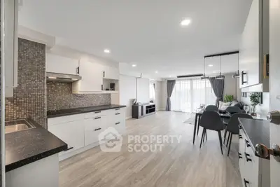 Spacious open-plan kitchen and living area with modern design and ample natural light.