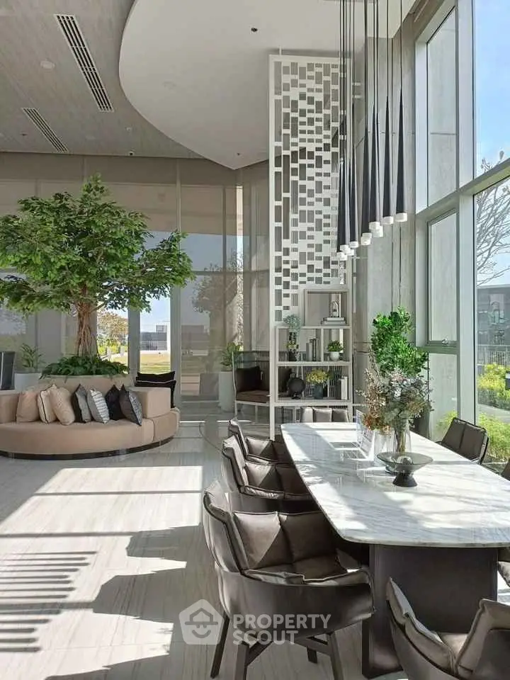 Luxurious modern living room with high ceilings, elegant decor, and abundant natural light.