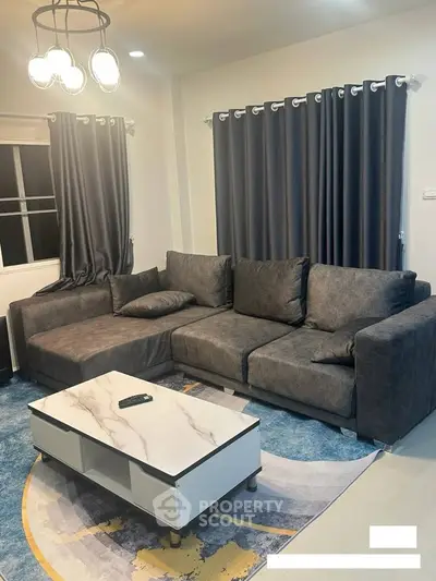 Modern living room with stylish gray sofa and chic marble coffee table