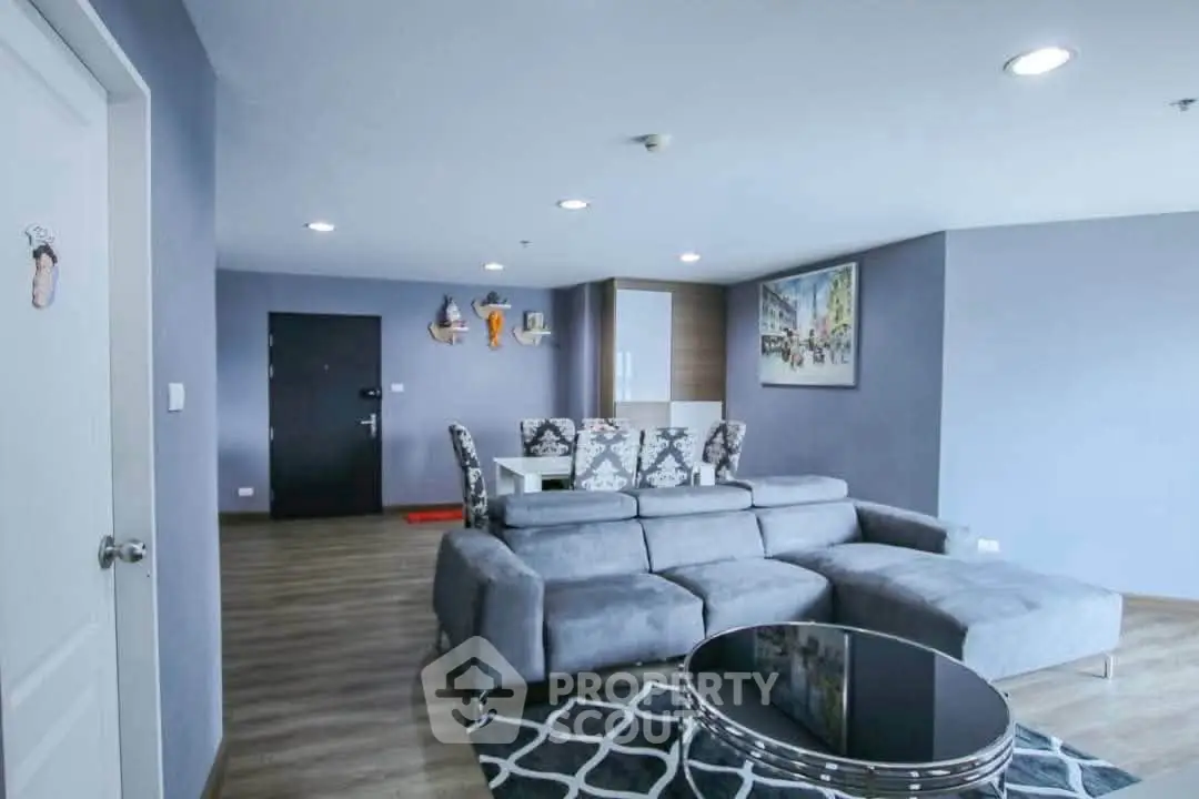Spacious modern living room with stylish gray sofa and elegant decor