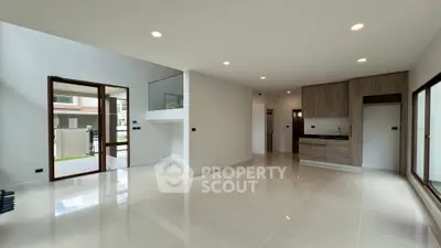 Spacious modern living room with open kitchen and large windows