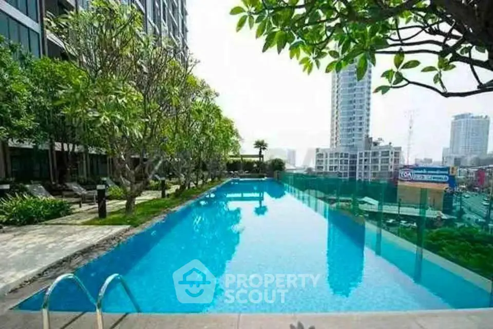 Luxurious rooftop pool with stunning city views in modern high-rise building.