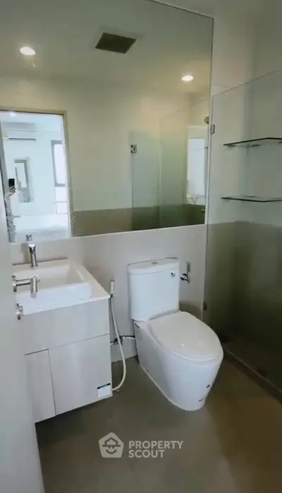 Modern bathroom with sleek fixtures and glass shower enclosure