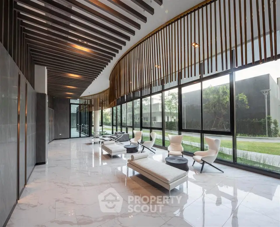 Luxurious modern lobby with sleek design and floor-to-ceiling windows offering garden views.