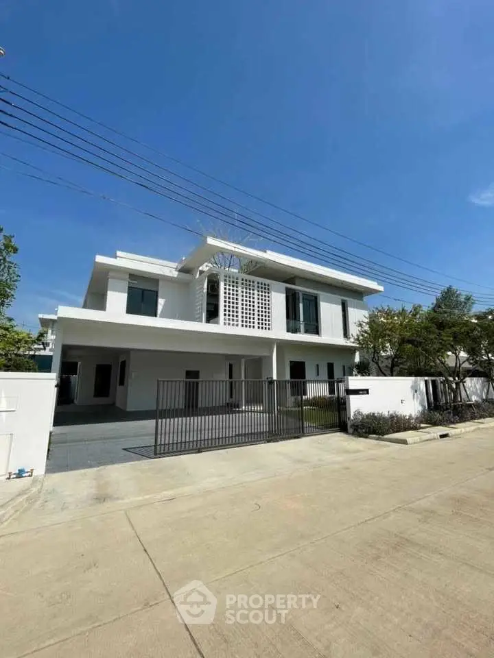 Stunning modern white villa with spacious driveway and lush greenery