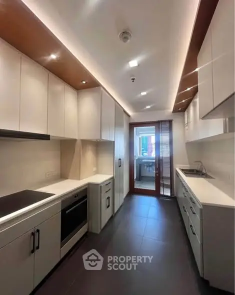 Sleek modern kitchen with closed layout and high-end appliances