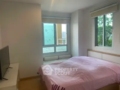 Cozy bedroom with large windows and modern decor