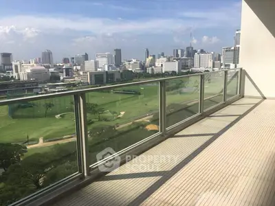 Spacious balcony with stunning cityscape and golf course views, perfect for relaxation and entertainment.