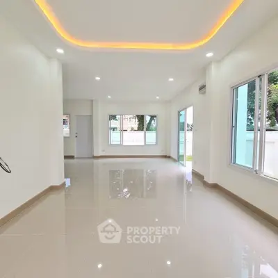 Spacious modern living room with glossy tiled floors and ambient lighting