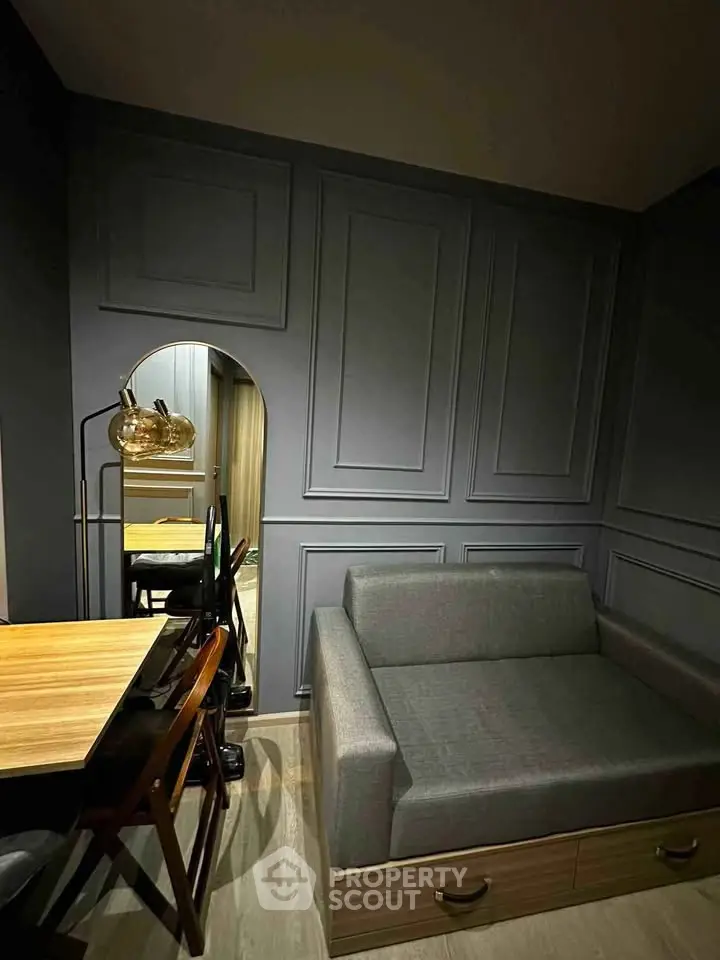 Stylish modern living room with sleek gray sofa and elegant wooden table, perfect for urban living.