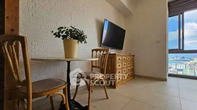 Charming living room with city view, featuring a cozy dining area and wall-mounted TV.