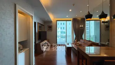 Modern living room with elegant decor and large windows offering a bright and airy ambiance.