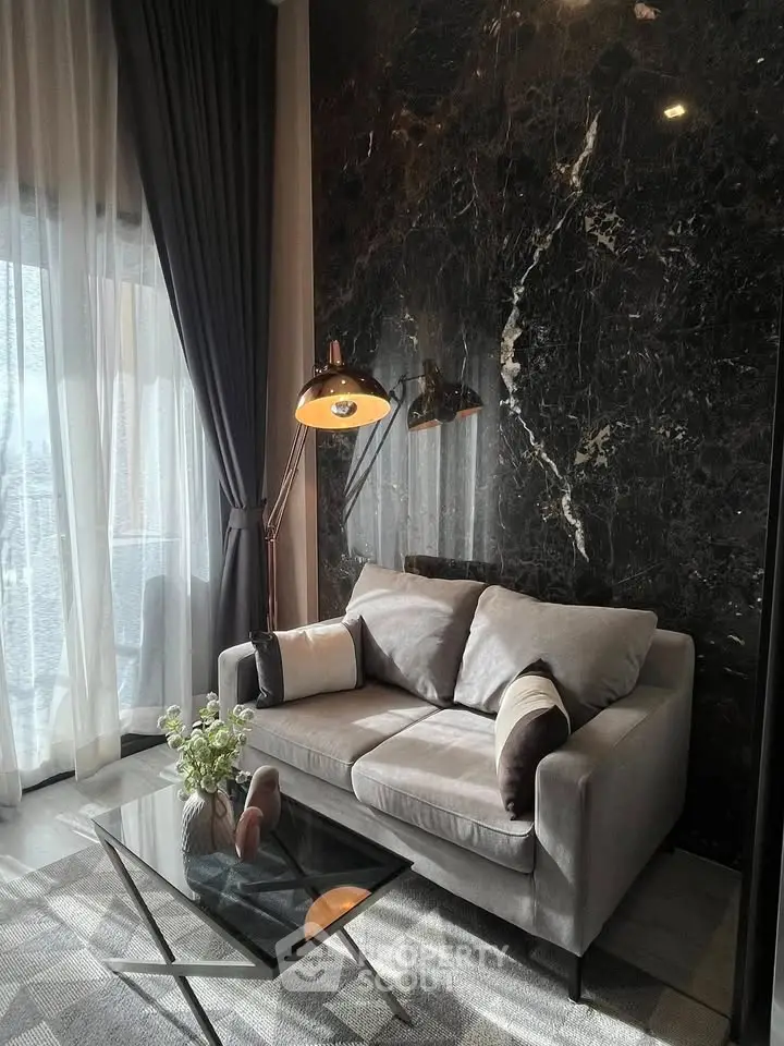 Elegant living room with marble accent wall and cozy sofa