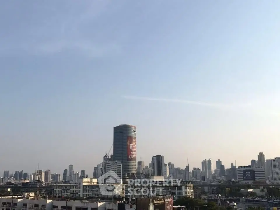 Stunning cityscape view showcasing modern skyscrapers under a clear blue sky, perfect for urban living enthusiasts.