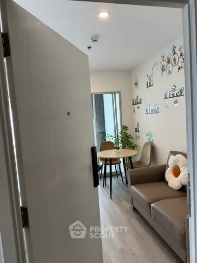 Charming living room with cozy sofa and dining area, perfect for modern living.