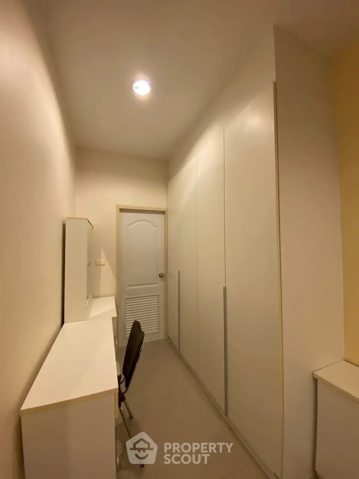 Compact study room with built-in storage and desk, ideal for efficient home office setup.