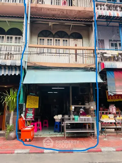 Charming multi-story building with street-level shop in vibrant urban setting.