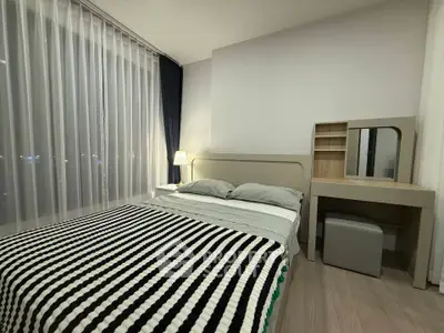 Modern bedroom with stylish decor and large windows for natural light