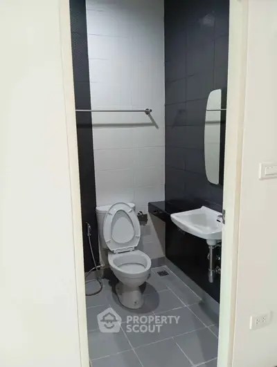 Modern bathroom with sleek design and minimalist fixtures in a contemporary apartment.