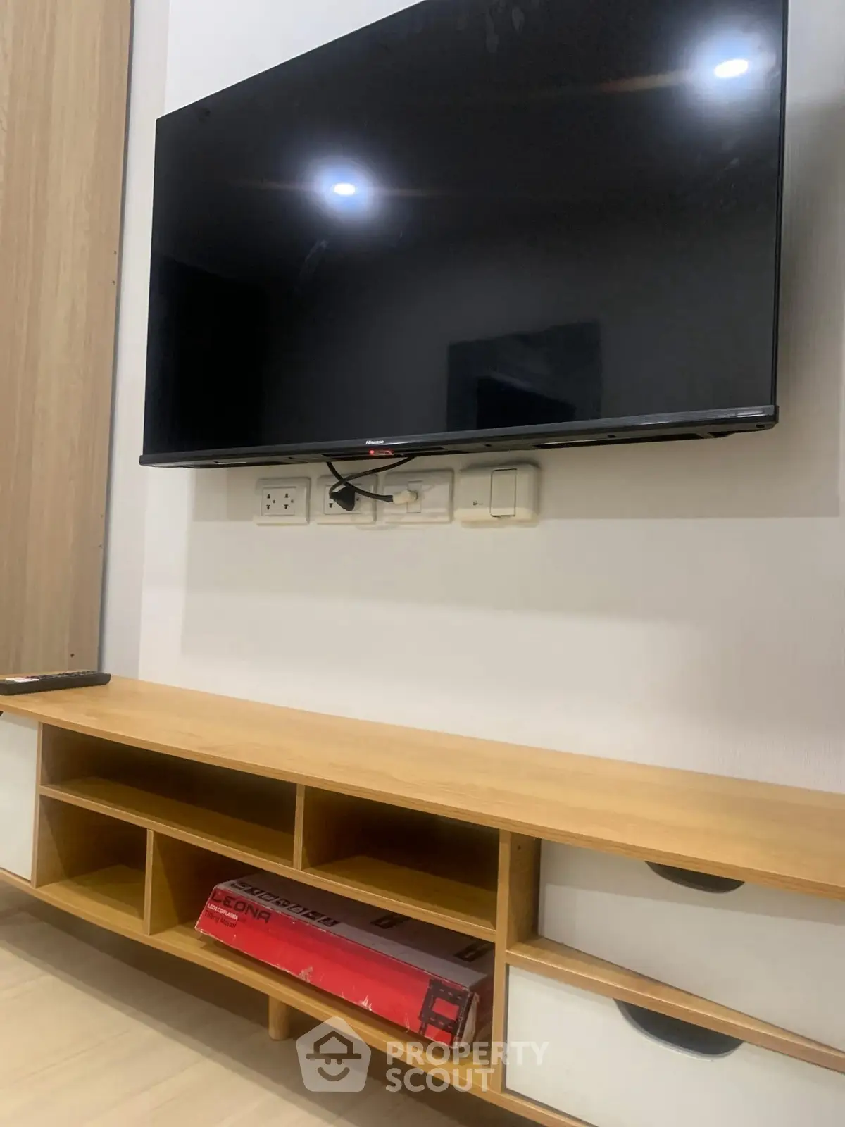 Modern living room with wall-mounted TV and stylish wooden console