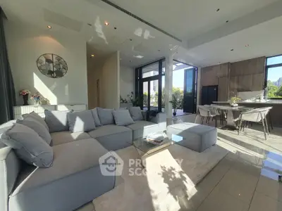 Luxurious open-plan living room with modern decor and abundant natural light