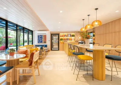 Spacious modern living area with stylish decor and ample natural light.