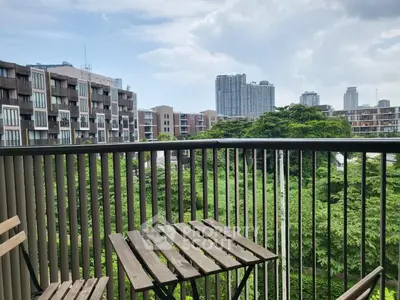 Charming balcony with cityscape and lush greenery views, perfect for relaxation.