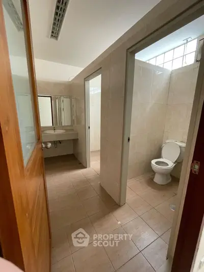 Spacious bathroom with modern fixtures and neutral tiles, perfect for comfort and functionality.