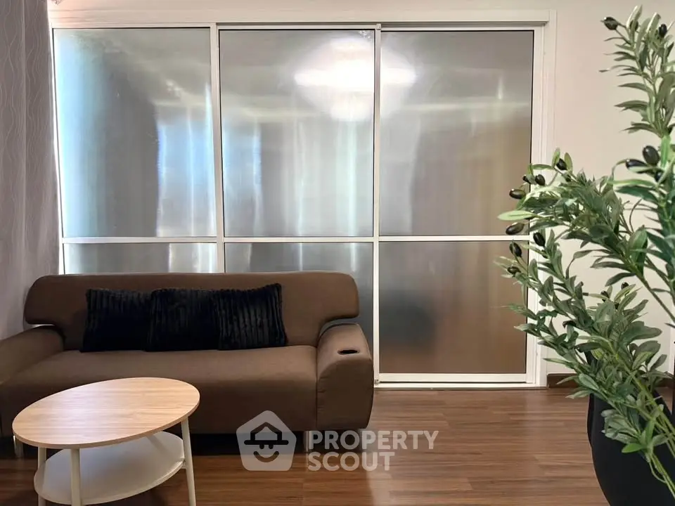 Modern living room with sleek brown sofa and stylish round coffee table