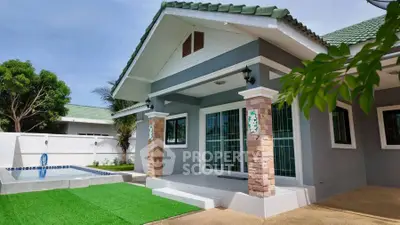 Charming single-story home with green roof and inviting front porch