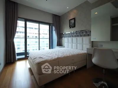 Modern bedroom with large window and stylish decor in luxury apartment