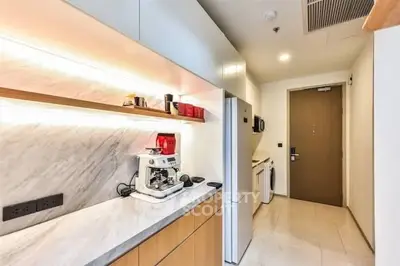 Modern kitchen with sleek appliances and marble countertops in a stylish apartment.