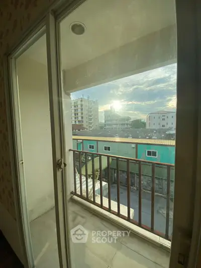 Cozy balcony with city view and morning sunlight