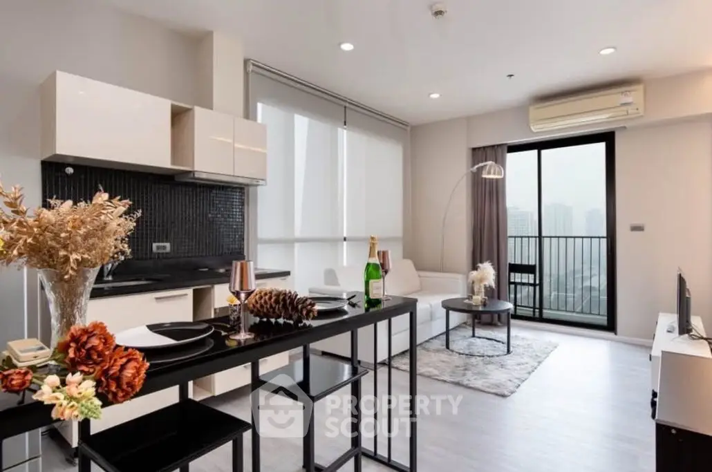 Modern open-plan living room with balcony and city view, featuring sleek furniture and stylish decor.