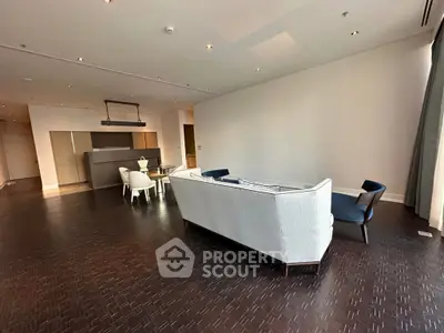 Spacious modern living room with elegant furniture and open kitchen layout