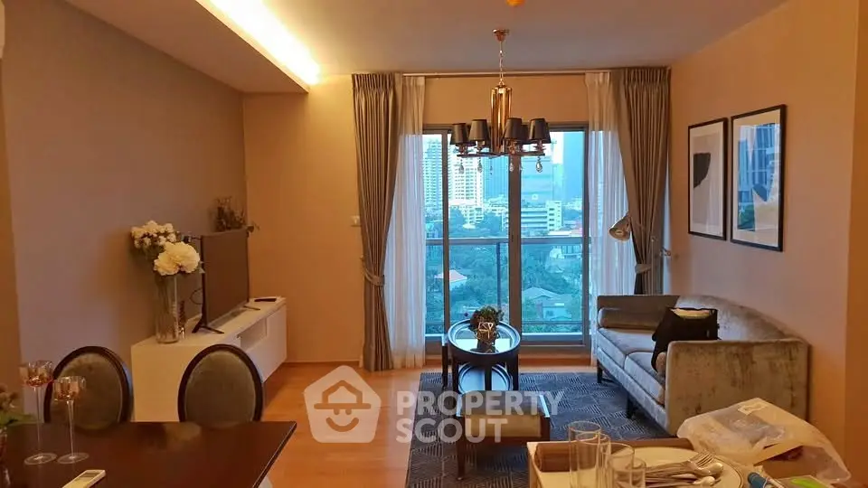 Elegant living room with city view, modern decor, and cozy seating area.