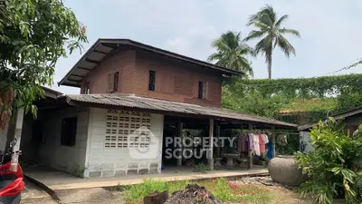 Charming rustic house with lush greenery and traditional architecture, perfect for serene living.